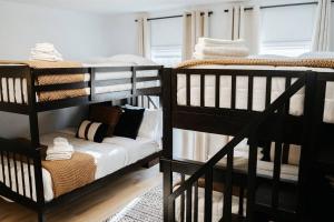 a couple of bunk beds in a room at New! Mountain Retreat HotTub, Fire Pit, Pool Table in Thornton