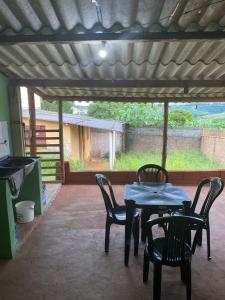 einen Tisch und Stühle auf einer Terrasse mit Aussicht in der Unterkunft CASA NA SERRA in São Roque de Minas