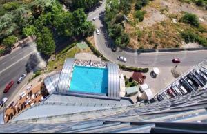 arial view of a building with a swimming pool at King david royal dan floor 21 a in Tbilisi City