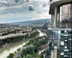 uma vista para um rio a partir do topo de um edifício em King david royal dan floor 21 a em Tbilisi