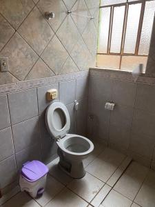 a bathroom with a toilet and a window at CASA NA SERRA in São Roque de Minas
