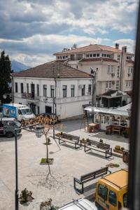 een uitzicht op een parkeerplaats met banken en gebouwen bij Delago in Ohrid