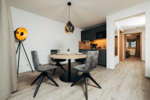 a kitchen and dining room with a table and chairs at Living Mountain Tannheim in Tannheim