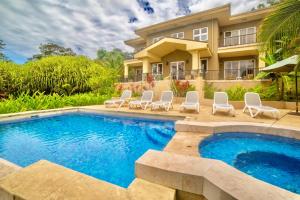 a villa with a swimming pool and a house at Red Frog Beach Island Resort in Bocas del Toro