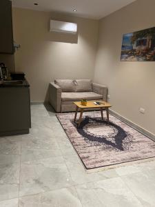 a living room with a couch and a coffee table at Regal view Aparthotel in Cairo