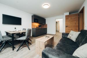 a living room with a couch and a table at Living Mountain Tannheim in Tannheim