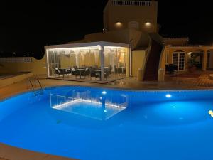 a swimming pool at night with blue lights at Quinta Nova Vale Del Rey in Carvoeiro