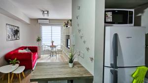 a living room with a refrigerator and a red couch at Movistar Arena "Rincón de ensueño" Palermo in Buenos Aires