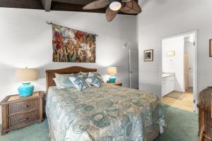a bedroom with a bed and a painting on the wall at Conveniently located two bedroom two bath HK319 in Wailea