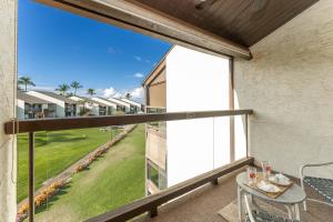 a balcony with a table and a large window at Conveniently located two bedroom two bath HK319 in Wailea