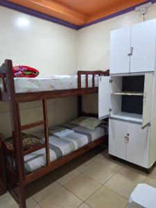 a room with two bunk beds and a refrigerator at Apart Hotel - Alter Temporada in Manaus