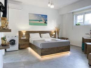 a bedroom with a bed and a washing machine at Sunset Seaside Apartments & Studios in Rethymno