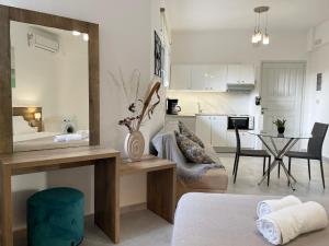 a kitchen and a living room with a table at Sunset Seaside Apartments & Studios in Rethymno