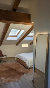 a bedroom with a bed and a skylight at Charming Barolo Wine Loft in Monforte dʼAlba