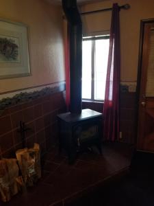 a black stove in a room with a window at Timberline Lodge in Big Bear Lake