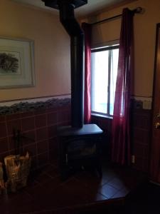 a wood stove in a room with a window at Timberline Lodge in Big Bear Lake