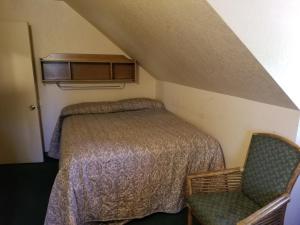 a bedroom with a bed and a chair at Timberline Lodge in Big Bear Lake