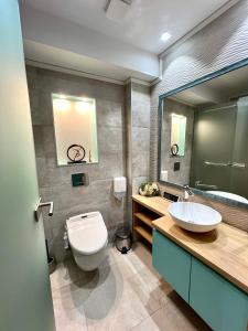 a bathroom with a white toilet and a sink at House4You - Blănari 4 in Bucharest