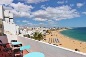a view of the beach from the balcony of a hotel at Casa dos Tios in Albufeira