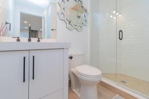 a white bathroom with a toilet and a shower at My cozy home in Toronto in Toronto