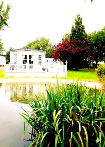 a white house in the middle of a pond at Sunrise Holidays Skegness - Diamond in Skegness