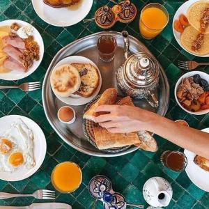 una mesa cubierta con un plato de desayuno en GITE Take Ur time, en Merzouga