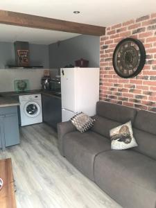 a living room with a couch and a brick wall at Maison in Béziers