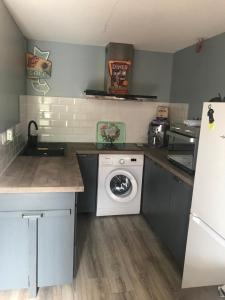 a kitchen with a white washing machine in it at Maison in Béziers