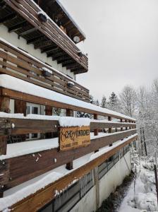 a building covered in snow with a sign on it at Echo des montagnes in Chalmazel Jeansagniere