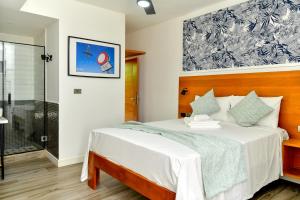 a bedroom with a bed and a shower at Honky Tonk Punta Cana in Punta Cana