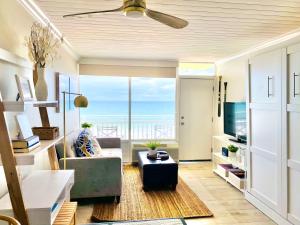 a living room with a view of the ocean at Sugar Sands - Ocean front at Symphony Beach Club ! in Ormond Beach