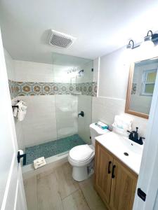 a bathroom with a shower and a toilet and a sink at Sugar Sands - Ocean front at Symphony Beach Club ! in Ormond Beach