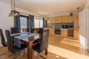 a kitchen and dining room with a table and chairs at Haus Maria in Ellmau