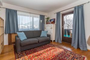 a living room with a couch and a window at Haus Maria in Ellmau