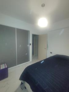 a bedroom with a bed and a light on the ceiling at Dpto San Martin in San Salvador de Jujuy