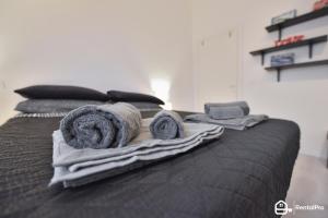 a bed with towels and pillows on top of it at Relax House Marche in Poggio San Marcello 