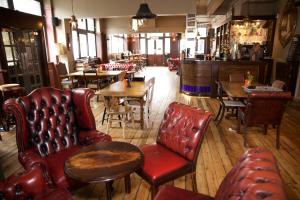 a living room filled with furniture and chairs at The Captain Cook in London