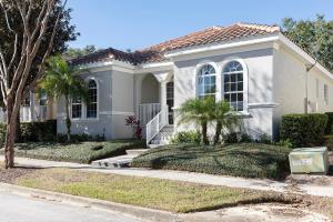 a house with a palm tree in front of it at W456 - Gleaming Retreat With Private Pool at Reunion in Kissimmee