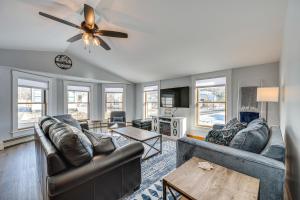 a living room with two couches and a ceiling fan at Comfortable Lincoln Home Walk to Main Street! in Lincoln