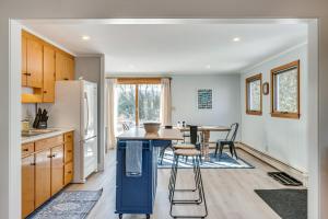 a kitchen with a table and chairs and a refrigerator at Comfortable Lincoln Home Walk to Main Street! in Lincoln