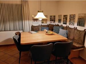 a dining room table with chairs and a bowl of fruit on it at Villa SKYLO in Winterberg