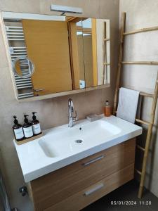 a bathroom with a sink and a mirror at Vista mare by Oikies Rentals in Neoi Epivates