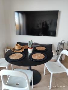 a black table with hats on top of it at Vista mare by Oikies Rentals in Neoi Epivates