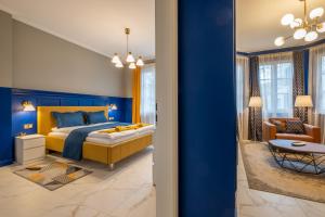 a blue bedroom with a bed and a living room at Sofia’s Classy Blu -2 Bedrooms in Sofia