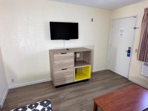 a living room with a tv on a wall at Days Inn by Wyndham San Marcos in San Marcos