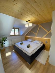 a bedroom with a large bed in a attic at Chata Petra in Oravský Biely Potok