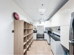 a kitchen with white counters and white appliances at Joyful Journeys in Dubai