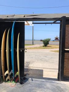 a group of surfboards are lined up in a rack at Pointbreak Surf Camp in Huanchaco