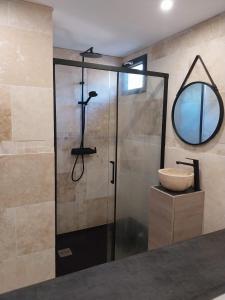 a bathroom with a shower with a sink and a mirror at Chalet détente proche plage in La Ciotat