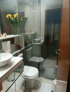 a bathroom with a toilet and a sink and a shower at Aconchego 1 in São Roque